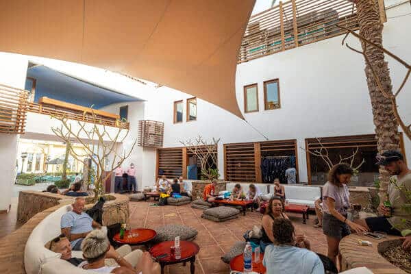 Camel Dive Center- Courtyard with divers enjoying a drink and logging dives