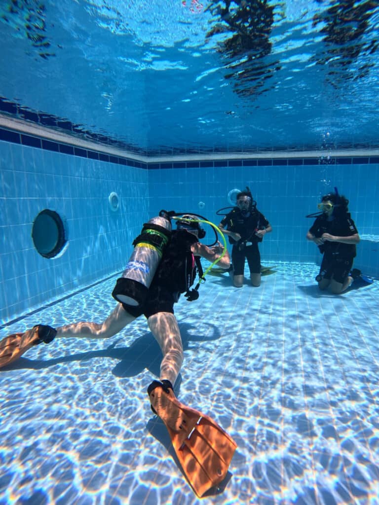 WhatsApp Image 2026-09-16 at 15.39.36 First-time divers practising scuba skills with an instructor in the Camel Dive Club training pool