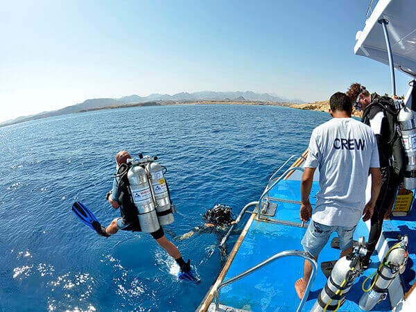Camel Dive boats Diver doing giant stride into the water
